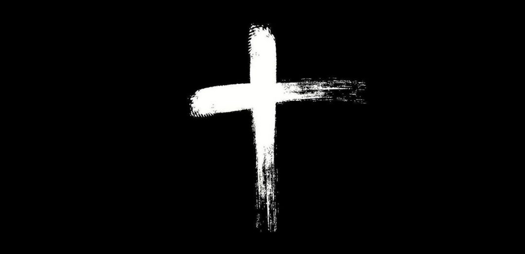 White cross on a black background. Cross as if drawn in ashes, but in negative (i.e. white on black)